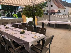 a table with white tables and chairs on a patio at Landgasthof Krone in Lauterach