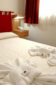 Giường trong phòng chung tại Hotel Patio del Mar