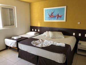 Cama o camas de una habitación en Saint Patrick Praia Hotel