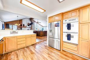 a kitchen with wooden cabinets and stainless steel appliances at Park Avenue Tahoe Lodge in Homewood