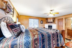 a bedroom with a bed and a ceiling fan at Park Avenue Tahoe Lodge in Homewood