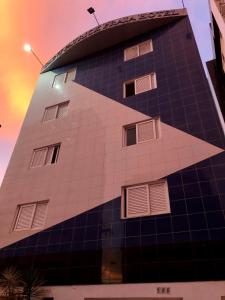 a building with windows on the side of it at Saint Patrick Praia Hotel in Maceió