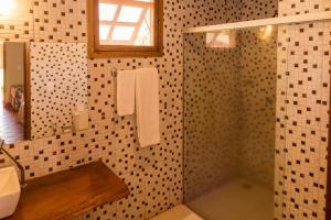 a bathroom with a shower and a sink at Eco Resort Foz do Marinheiro in São João do Marinheiro