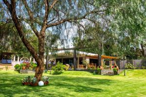 a house with a tree in the yard at Kinga Homes Boutique Hotel in Moshi