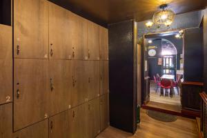 a room with wooden cabinets and a dining room with a table at The Clock Hostel & Suites in Cartagena de Indias