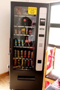 a black vending machine with drinks and soda at Midrand Bed and Breakfast in Midrand