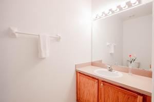 a bathroom with a sink and a mirror at Berkley Lake Townhomes in Kissimmee