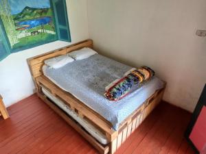 a small bed sitting in a room with at Ecolife Calima in Calima