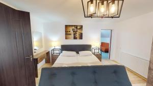 a bedroom with a bed and a blue couch at Boutique Hotel Shale in Bakuriani +110 photos