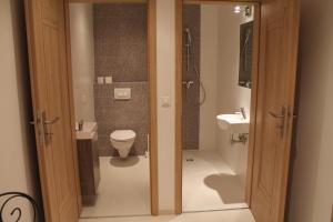 a bathroom with a toilet and a sink at Studio Anna in Kraków +73 photos