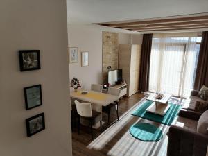 a living room with a table and a dining room at Katia М14 Milmari Resort in Kopaonik