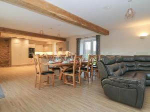 a living room with a table and chairs and a couch at Ploughman's Rigg in Harrogate