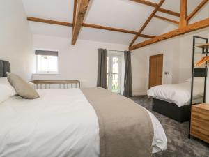 a bedroom with two beds in a room with wooden ceilings at Miller's Wheel in Harrogate