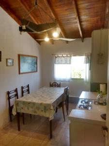 a kitchen with a table and a kitchen with a stove at LUZ MAR San Clemente del Tuyú in San Clemente del Tuyú