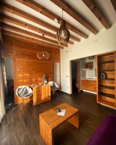 a living room with wooden walls and a table at Zagreb Camp Bungalows in Rakitje