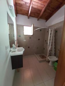a bathroom with a sink and a toilet at Hostel Meridiano 71 in El Bolsón