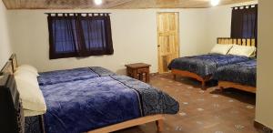 מיטה או מיטות בחדר ב-Cabaña La Victoriana