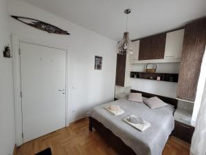 a bedroom with a bed with two towels on it at Apartment Iris in Belgrade