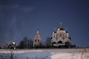 a church with snow on its domes at night at Russkaya Izba s baney in Suzdal