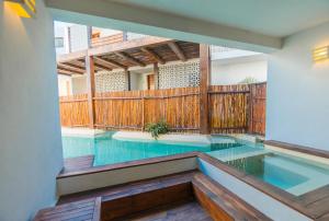 an indoor swimming pool with a wooden fence at O' Tulum Boutique Hotel - Adults Only in Tulum