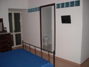 a bedroom with a bed and a toilet in it at B&B Il Convento in Agropoli