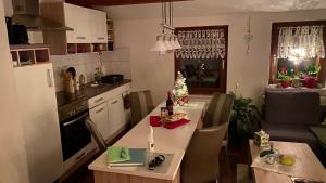 a kitchen and living room with a table and chairs at Froeschlein - no craftsmen fitters in Ilmenau