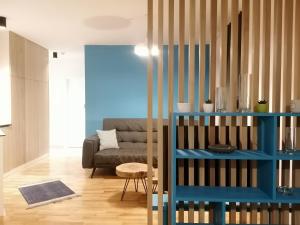 a living room with a couch and a blue shelf at CENTRALA Jahorina in Jahorina