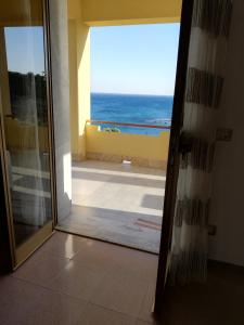 a door to a room with a view of the ocean at Villa Fiorella in Sciacca