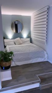 a bedroom with a large bed with a mirror at Luxury Rooftop Apartment in Netanya in Netanya