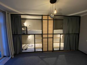 a room with two bunk beds and a mirror at Ehostel360 in Ivano-Frankivsʼk