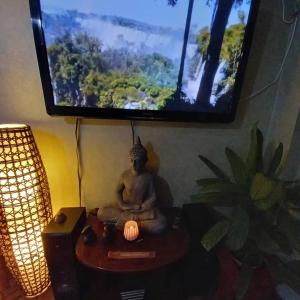 a statue sitting on a table in a room with a tv at Hostal Tunquelen in Valparaíso