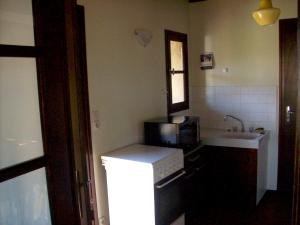 a small kitchen with a refrigerator and a sink at Charmante maison à Puy-l'Évêque avec jardin et balcon in Puy-lʼÉvêque +14 photos