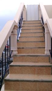 a set of stairs with white railings at Studio with sea view terrace and wifi at Souillac 1 km away from the beach in Souillac