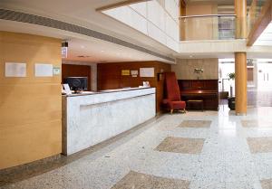 a lobby with a reception desk in a building at Torreluz Senior in Almería