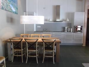 a kitchen with a wooden table and chairs at Sallainen Panvillage in Salla