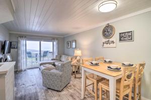 a living room with a table and a couch at Fernandina Beach Condo, Steps to Shore and Pool! in Fernandina Beach