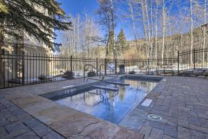a swimming pool in a yard next to a fence at Ski-InandSki-Out Beaver Creek Condo with Mtn Views! in Beaver Creek
