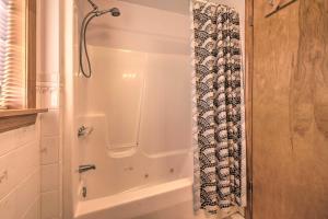 a shower in a bathroom with a shower curtain at Private Hot Tub and Fireplace Poconos Home! in Pleasant Mount +17 photos