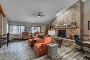 a living room with a couch and a fireplace at AmericInn by Wyndham Coon Rapids in Coon Rapids