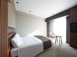 Кровать или кровати в номере Hotel Trad Hakata