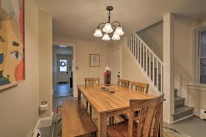 a dining room with a wooden table and chairs at Cozy Lambertville Abode in the Heart of Downtown! in Lambertville