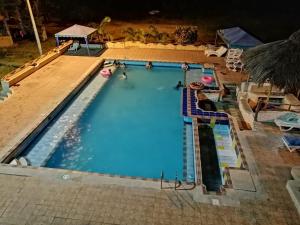 an overhead view of a swimming pool at night at Hosteria Mar de Plata in Cabuyal