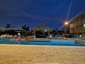 a swimming pool at a resort at night at Hosteria Mar de Plata in Cabuyal