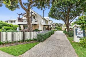 a street with a fence and a house at Seahaven Village in Barwon Heads