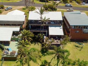 an aerial view of a building with palm trees at Panorama Place on Jones Beach in Minnamurra