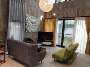 a living room with a couch and a television at 350 Lodge in Taitung City