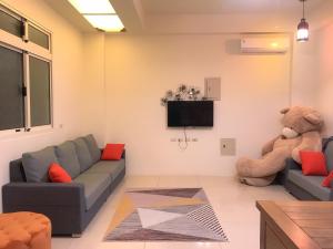 a living room with a teddy bear sitting on the wall at Star Moon Secretarea in Yuchi