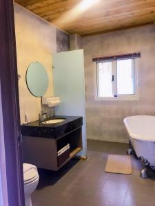 a bathroom with a sink and a toilet and a tub at Star Moon Secretarea in Yuchi