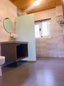 a bathroom with a sink and a mirror and a toilet at Star Moon Secretarea in Yuchi