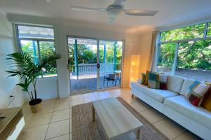 a living room with a couch and a table at Tree Escape in Rainbow Beach